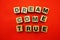 Dream come true word created with cubes alphabet letters on red background