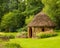 Dream English garden view with beautiful round thatched building