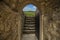 Dream and final goal fairy tale concept colorful picture of big world view from narrow arch shape entrance of medieval castle