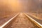 Dream journey. Railroad tracks at sunset time. Summer haze