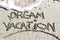 Dream vacation phrase handwritten on the beach