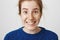 Dream and it will come true. Close-up shot of adorable caucasian woman with red hair and freckles smiling and looking