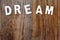 Dream word on wooden background
