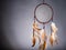 Dreamcatcher on a gray background, with space for an inscription. Cultural Amulet, Indian Culture