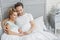 Dreamful man and woman enjoying morning in bedroom