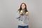 Dreamful young woman in gray sweater, scarf looking up, holding lemons isolated on grey wall background. Healthy fashion