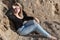 Dreamily young woman relaxing at sea coast.