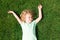 Dreaming adorable little girl lying on grass