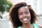 Dreaming african american woman in a green shirt outdoor