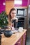 Dreaming beautiful girl reading design magazine in her kitchen, smiling