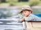 Dreaming boy lying in old boat on the river