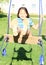 Dreaming girl on swing