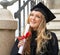 Dreaming of her perfect career. Inspired young graduate after graduation holding a diploma.