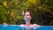 Dreaming woman in open swimming pool. Girl in open swimming pool. Summer vacation experience photo