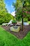 Dreamlike garden design with deck chair, grass, paths, flowers and other plants