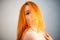 Dreammy fashion portrait of redhead woman in soft focus