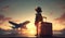 Dreams of travel. Child with a suitcase against the backdrop of a sunset