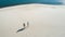 Dreamscape Portraiture: Aerial View Of Two People Walking On Sandy Dune