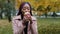 Dreamy African American young woman drinking coffee or tea in disposable cup, brooding millennial student girl enjoying