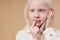 Dreamy albino child talking on phone