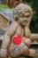 Dreamy angel statue with a crocheted red heart.