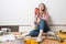 Dreamy beautiful girl painter sitting on floor