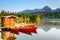 Dreamy boats stand near wooden bridge.