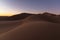 Dreamy desert concept at Twilight of dawn at desert dune of Erg Chigaga, at the gates of the Sahara. Morocco. Concept of travel