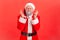 Dreamy elderly man in santa claus costume closing eyes and crossing fingers making a wish, christmas magic, winter holidays