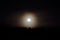 Dreamy full moon night sky over spruce tree forest and mountain