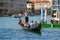 A dreamy gondolier drives a gondola with tourists, Venice. Italy