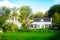 Dreamy photo of colonial style cottage amonst lush greenery of the trees. Glorious summer day in Kerikeri, New Zealand