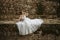 Dreamy portraits of beautiful bride on stone riverbank