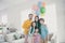 Dreamy positive cheerful people dad mom cuddle his three preteen little children celebrate anniversary party event near