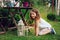 Dreamy romantic kid girl relaxing in evening summer garden decorated with lantern