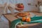 Dreamy shot of dainty hand holding a pomegranate over a table with tangerines and waffle for breakfast