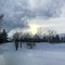 Dreamy Snowy Winter Twilight View with Sun Setting and Trees