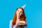 Dreamy, tender and feminine redhead caucasian girl thinking looking up thoughtful with tempting smile holding b-day cake