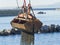 Dredge Clamshell Bucket unloading gravel in the water of a port