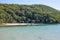 A dredger barge pumping watery sand over the headland