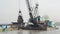 DREDGING RIVER: Wider shot crane scoops sand from river in giant bucket;from StockFootageWorld