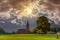 Drenthe landscape with Gothic Jacobus church  against a sky with dark clouds and breaking sunlight