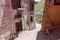 Drepung monastery just 8 km away from Lhasa, Tibet, Asia, white and red buildings, woman sitting and resting