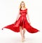 Dress rent service, fashion industry. Woman wears elegant evening red dress, white background