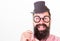 Dress for success. Man bearded hipster hold cardboard top hat and eyeglasses to look smarter white background. Dress