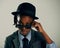 Dressed in his best. Studio shot of a cool ethnic boy peering over his sunglasses.