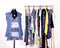 Dressing closet with colorful clothes arranged on hangers and a