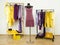 Dressing closet with complementary colors violet and yellow clothes.