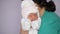 Dressing newborn girl in maternity hospital