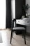 Dressing table corner with black wood power table and black wooden chair  and circular black mirror in natural light scene / cozy